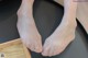 A pair of bare feet sitting on top of a table.