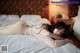 A woman laying on top of a bed in a bedroom.