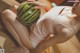 A woman in a pink bathing suit holding a watermelon.