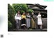 A group of women standing next to each other in front of a building.