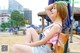 A woman sitting on a bench on the beach.