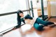 A woman laying on the floor in front of a window.